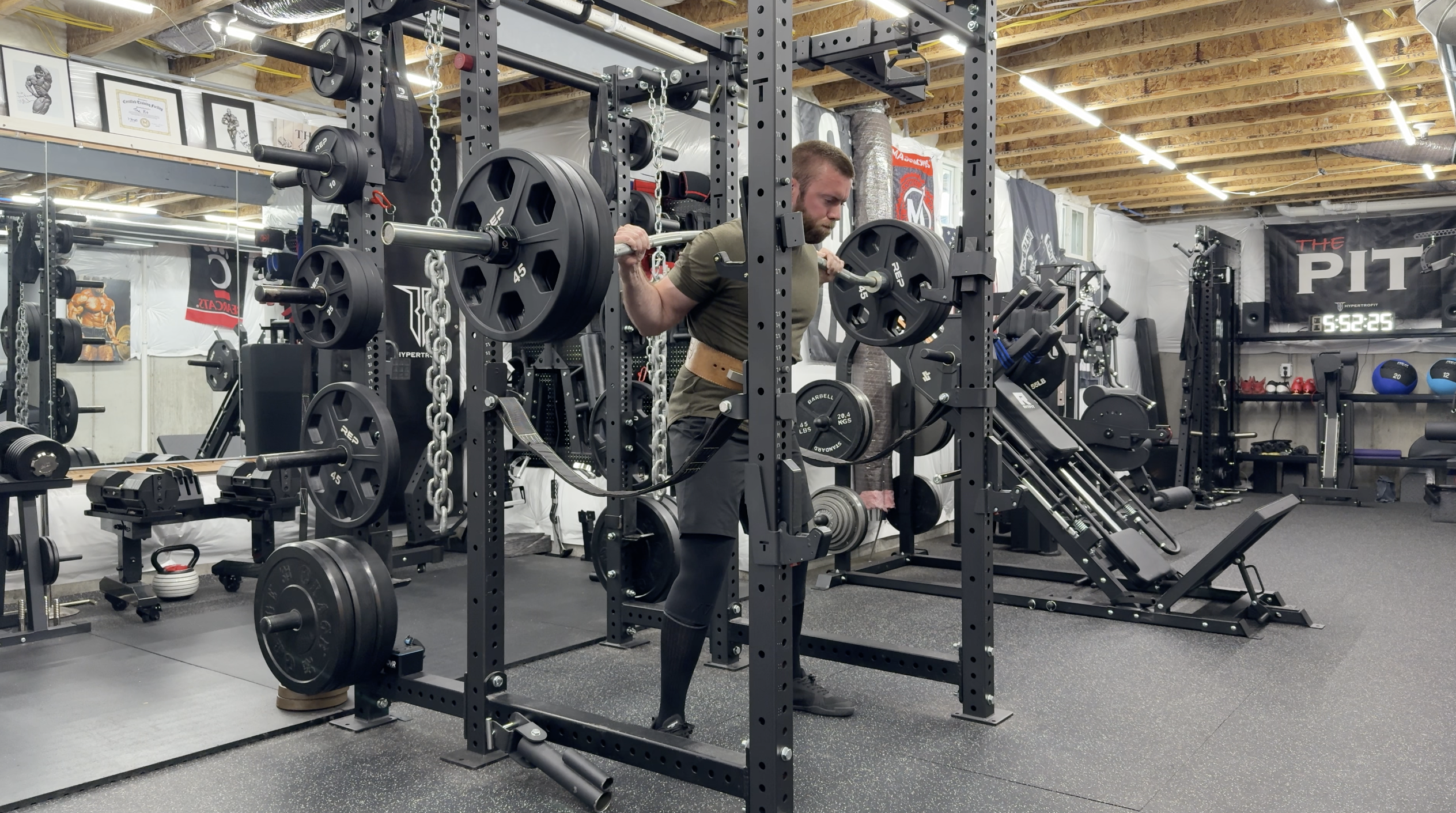 Kyle Blandford squatting with a Duffalo bar in a home gym